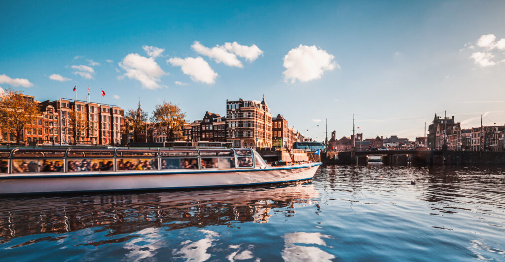 Cruising and sightseeing along Amstel canals on the water in Amsterdam, Netherlands